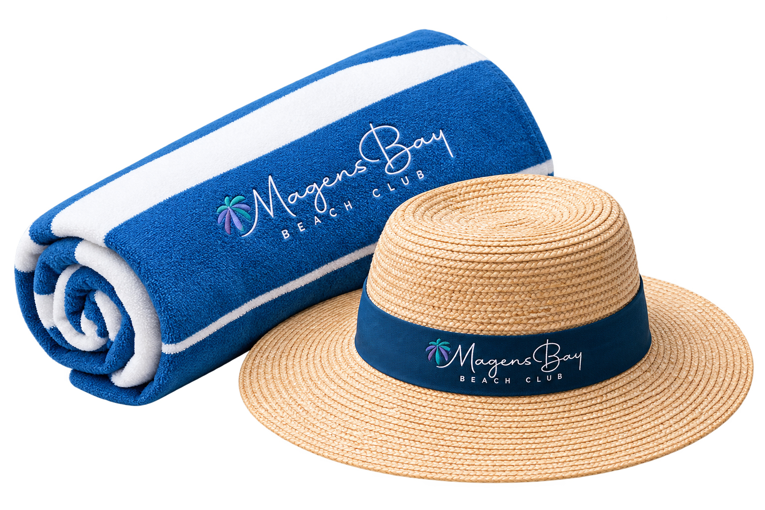 A rolled Magens Bay Beach Club towel and a straw sun hat